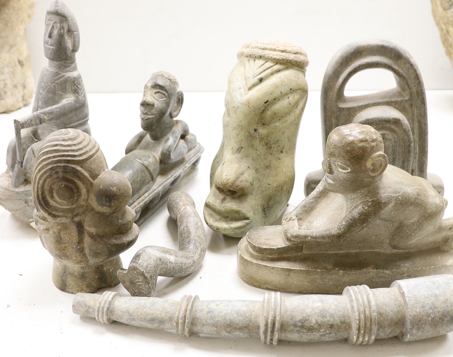 Eight Shona stone carvings, 1960s-70s including a kneeling figure and sleeping figure,both signed D.S. Dube, other figures, heads and abstract sculpture forms, tallest 35cm